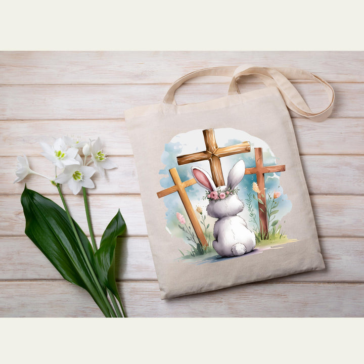 Inspirational Easter design with a bunny, floral elements, and three crosses symbolizing faith and resurrection.