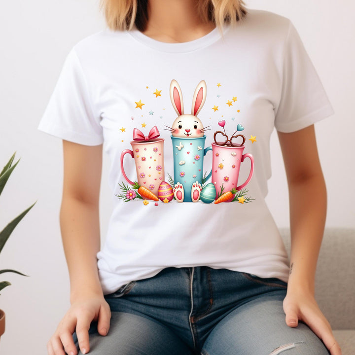 Fun coffee-themed Easter transfer featuring a bunny in decorated pastel cups, ideal for festive apparel.