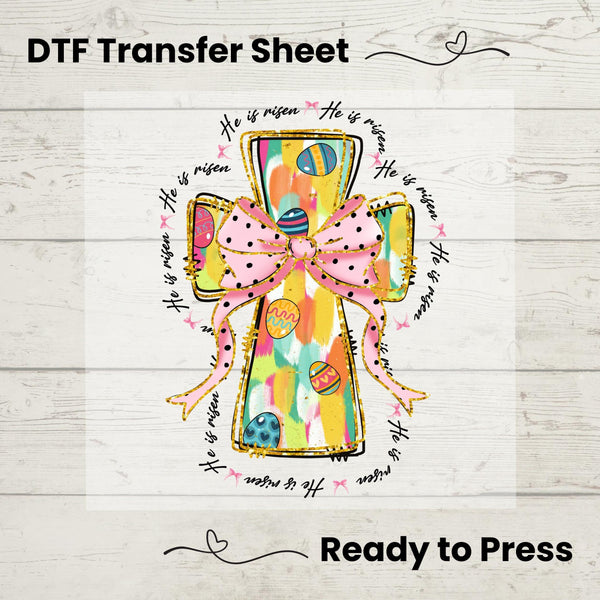 Colorful He Is Risen Cross DTF heat transfer with a pastel design, pink bow, and Easter eggs, ready to press on spring tees.
