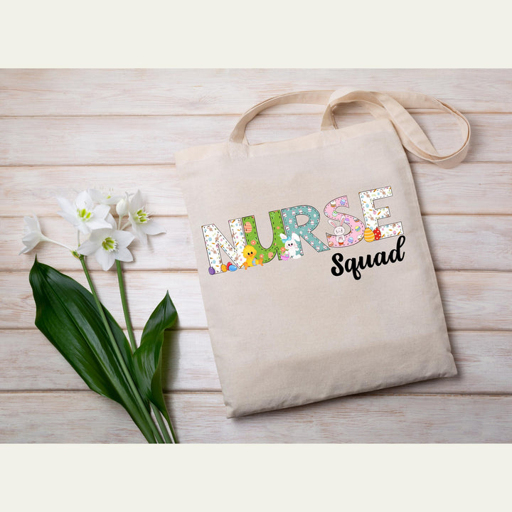 Festive medical team Easter heat transfer with cute bunnies, eggs, and colorful lettering for nurse squad apparel.