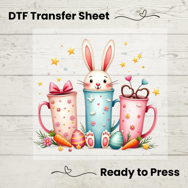 Cute Easter DTF transfer featuring a bunny inside pastel pink and blue coffee cups with eggs, carrots, and bows.