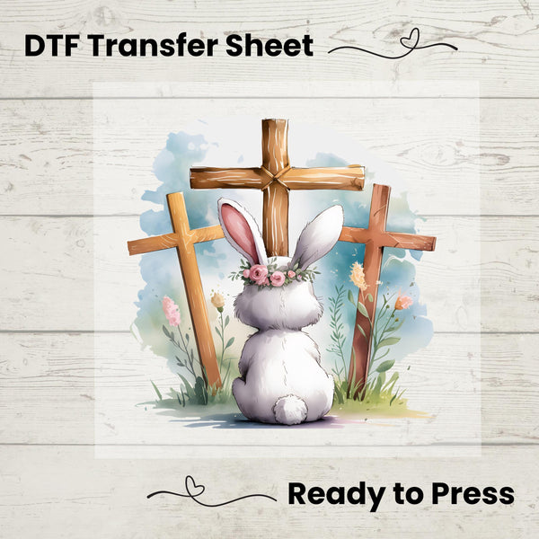 Faith-based watercolor DTF transfer featuring a bunny with a floral crown sitting in front of three wooden crosses.