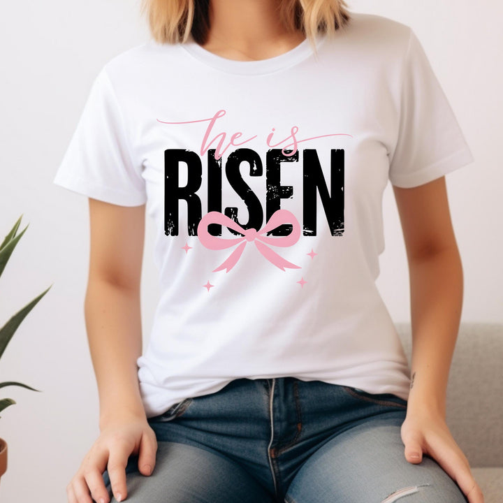 DTF transfer sheet with "He Is Risen" text and feminine pink bow, ideal for Easter t-shirts and crafts.