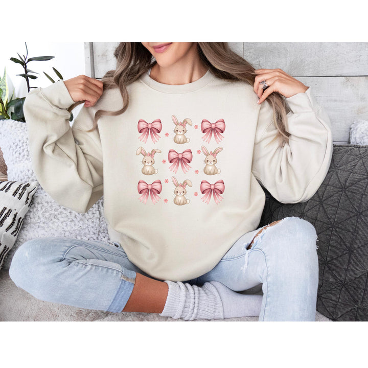 A stylish, pastel-colored DTF transfer featuring a repeating bunny and pink bow pattern for a delicate look.
