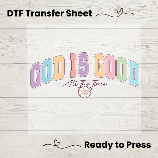 Faith-based DTF transfer featuring bold pastel "God Is Good" text, script "All The Time," and a cute lamb illustration.