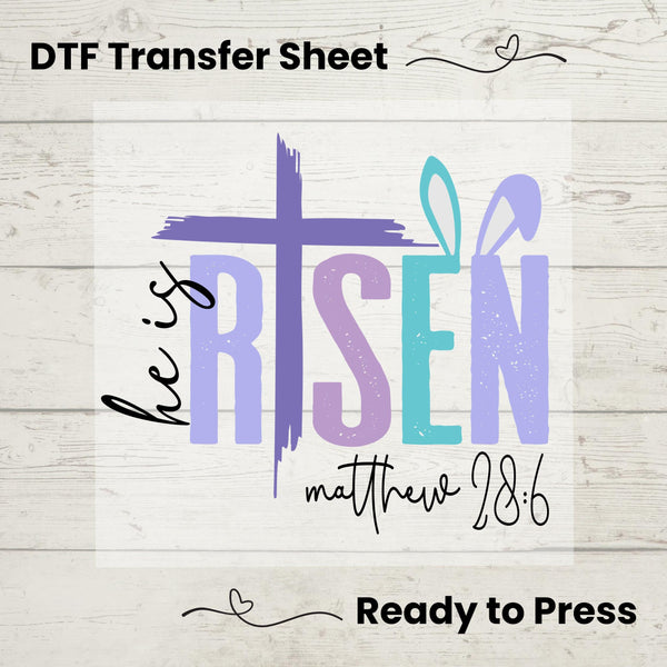 Easter He Is Risen DTF heat transfer with a bold purple cross and Matthew 28:6 verse, ready to press on spring tees.