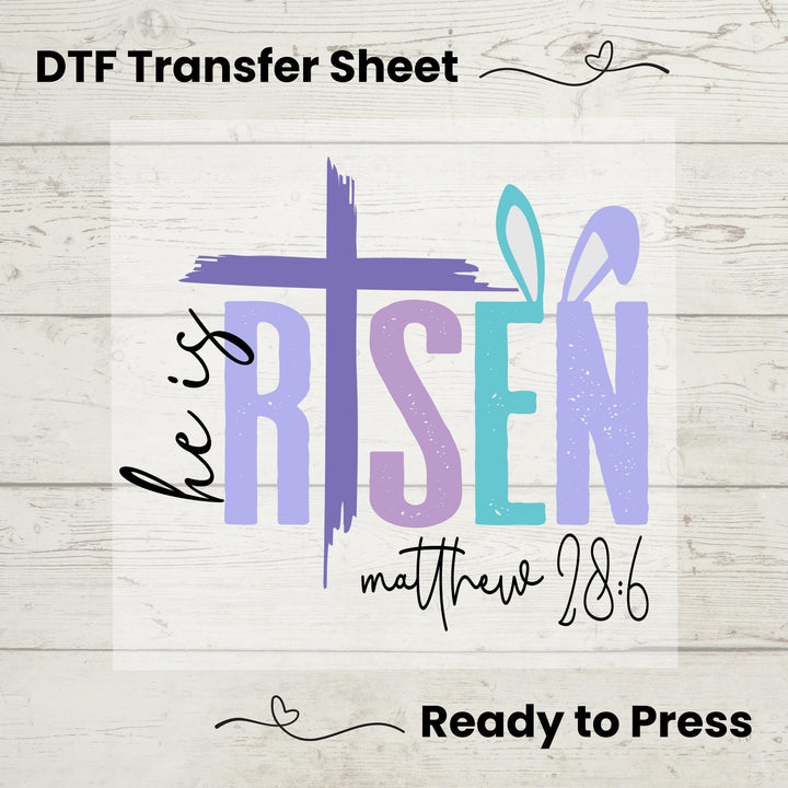 Easter He Is Risen DTF heat transfer with a bold purple cross and Matthew 28:6 verse, ready to press on spring tees.