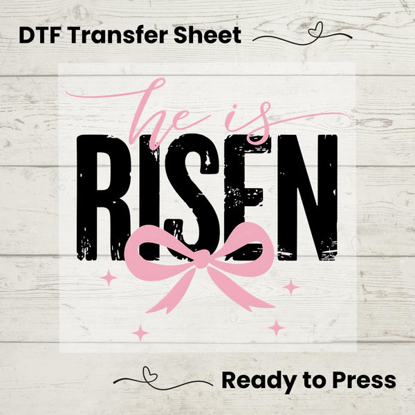 Christian Easter DTF transfer featuring "He Is Risen" in bold typography with a pink bow and decorative accents.