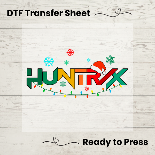 HUNTRX DTF transfer sheet with Christmas design on a wooden surface