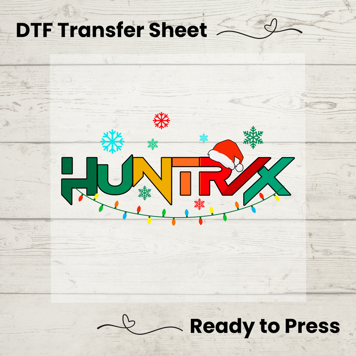 HUNTRX DTF transfer sheet with Christmas design on a wooden surface