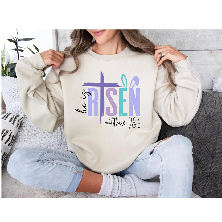 Christian heat transfer featuring a purple cross and He Is Risen design, perfect for Easter faith-based apparel.