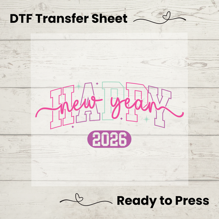 DTF transfer sheet with 'Happy New Year 2026' text on a wooden surface