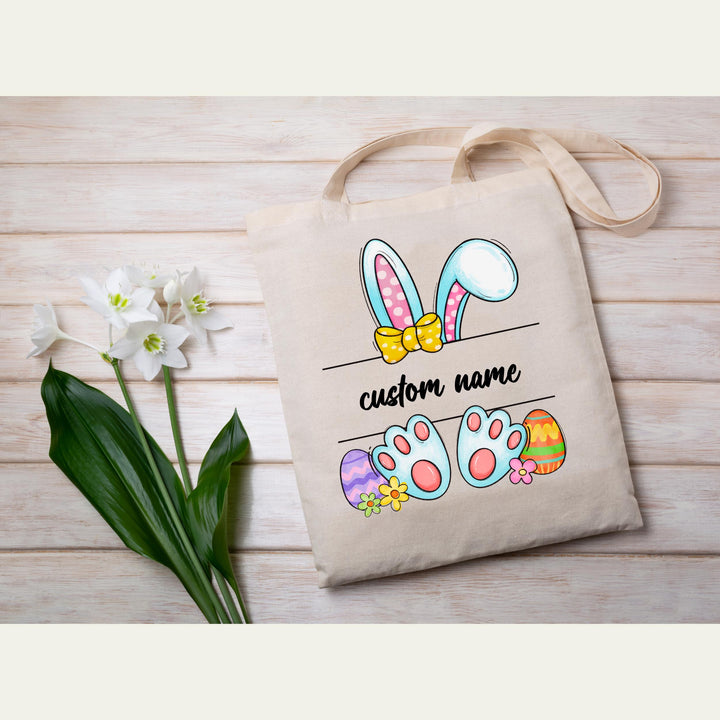 Custom name Easter heat transfer with bunny ears, pastel eggs, and adorable bunny paws for DIY Easter apparel