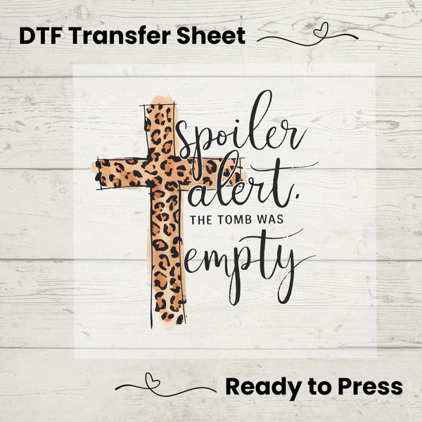 Christian Easter DTF transfer featuring a stylish leopard-print cross and the phrase "Spoiler Alert: The Tomb Was Empty."