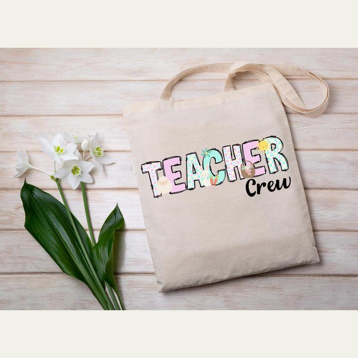 Festive teacher Easter heat transfer with playful pastel elements and fun designs for matching teacher crew shirts.