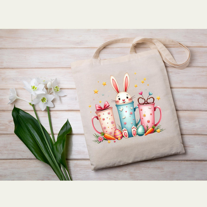 Fun and colorful Easter transfer with a bunny inside festive coffee cups, decorated with hearts and bows.