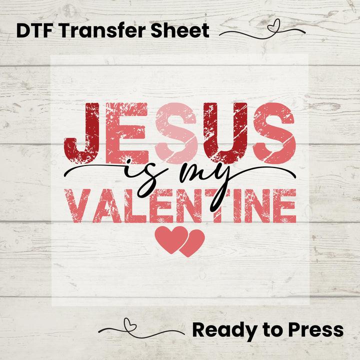 A graphic design of text 'Jesus is my Valentine' with hearts, intended as a DTF transfer sheet for application on garments, displayed on a wooden background with the text 'Ready to Press'.