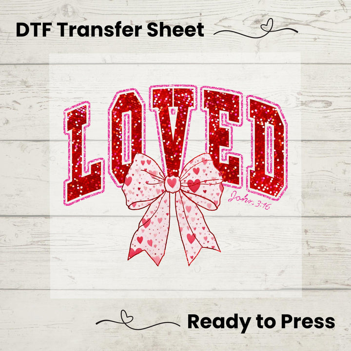 A graphic image showing a red and pink Valentine's Day themed DTF transfer design with the word 'LOVED' and a heart pattern, indicating it's ready to be pressed onto fabric.
