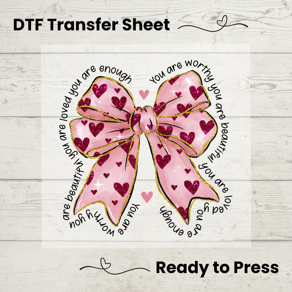 A digital image of a pink bow with hearts and text that reads 'you are enough', indicating it is a DTF (Direct to Film) transfer sheet ready for pressing onto fabric.