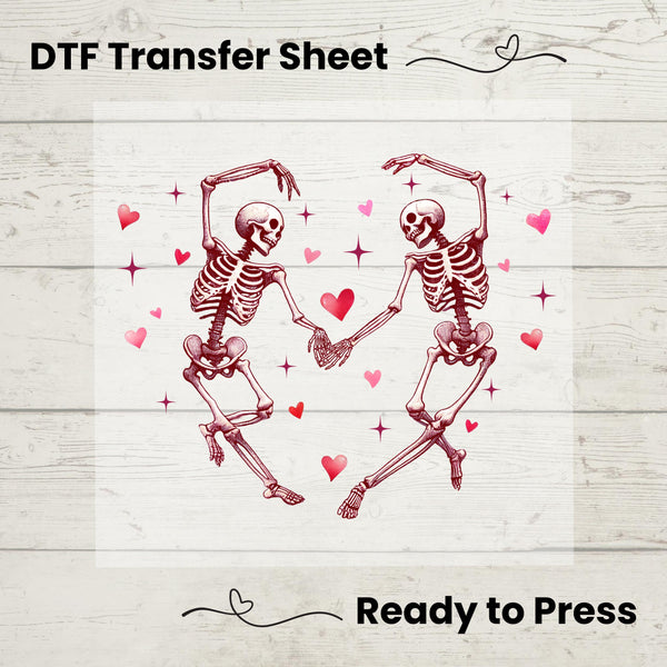 A graphic design of two skeletons dancing with hearts around on a white background, labeled as a DTF Transfer Sheet.