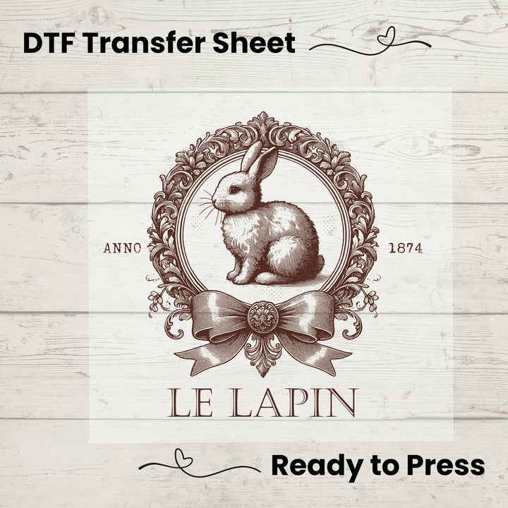 Elegant antique-style DTF transfer featuring a detailed rabbit, ornate frame, and bow with "Le Lapin" text.