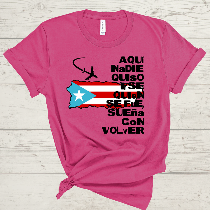 Pink t-shirt with Puerto Rican flag design and text on a wooden surface