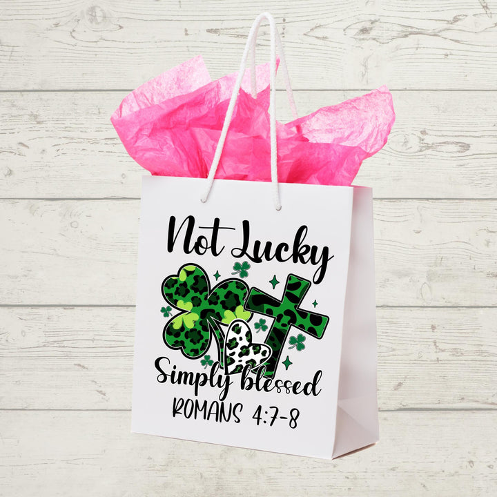 Not Lucky Simply Blessed DTF transfer featuring green leopard shamrocks, hearts, cross, and inspirational Romans 4:7-8 scripture—perfect for DIY faith apparel.