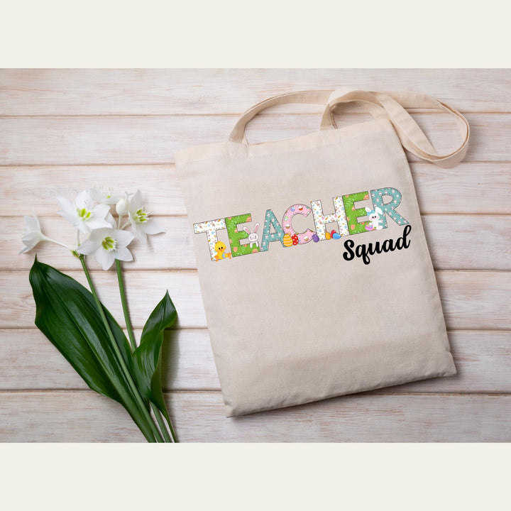 Festive teacher Easter heat transfer with playful pastel elements and fun designs for matching teacher squad shirts.