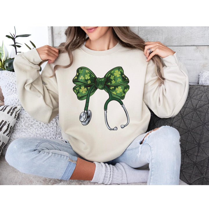 St. Patrick’s Day Nurse DTF transfer featuring a green coquette bow with shamrocks on a stethoscope, ideal for DIY nurse and medical apparel.