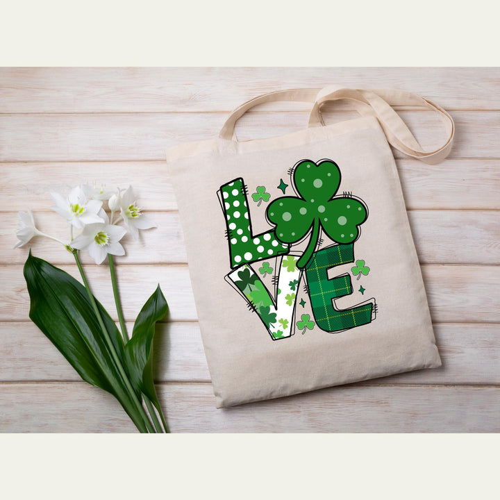 St. Patrick’s Day LOVE DTF transfer sheet featuring bold lettering with shamrocks, polka dots, and green plaid patterns for festive DIY apparel
