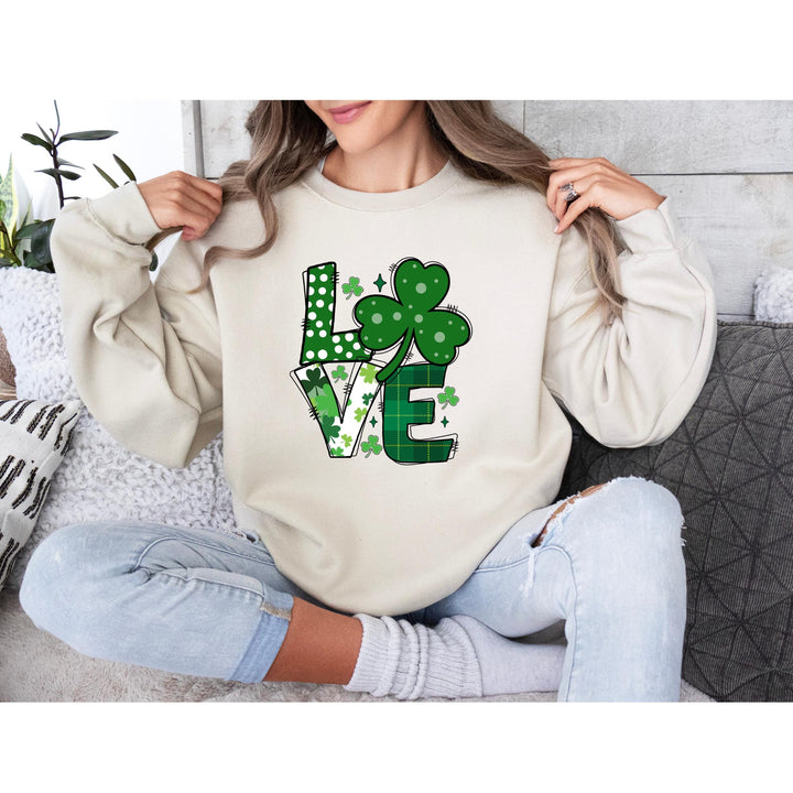 St. Patrick’s Day LOVE DTF transfer sheet featuring bold lettering with shamrocks, polka dots, and green plaid patterns for festive DIY apparel