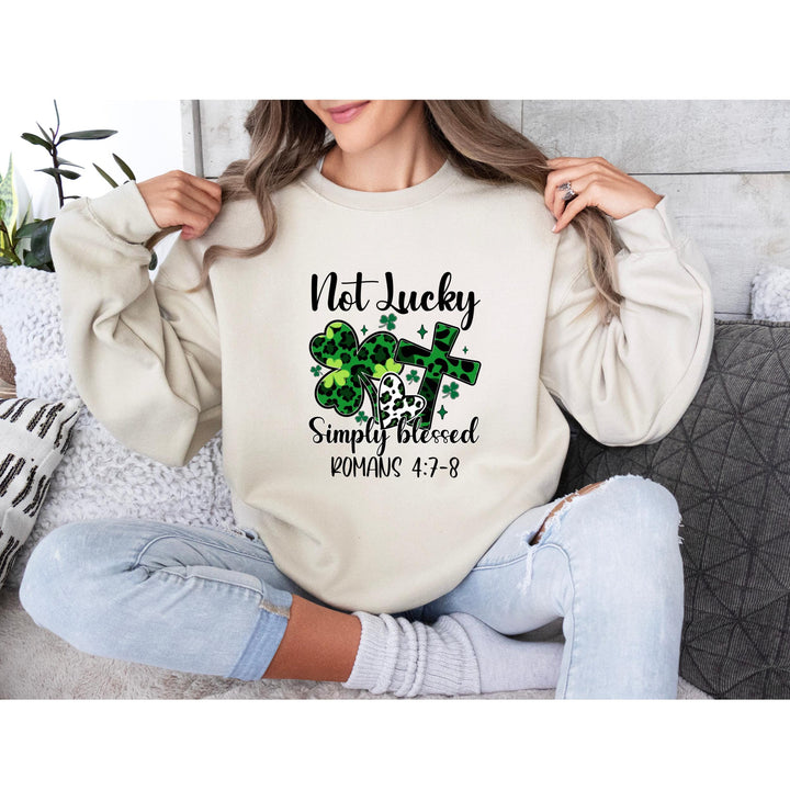 Not Lucky Simply Blessed DTF transfer featuring green leopard shamrocks, hearts, cross, and inspirational Romans 4:7-8 scripture—perfect for DIY faith apparel