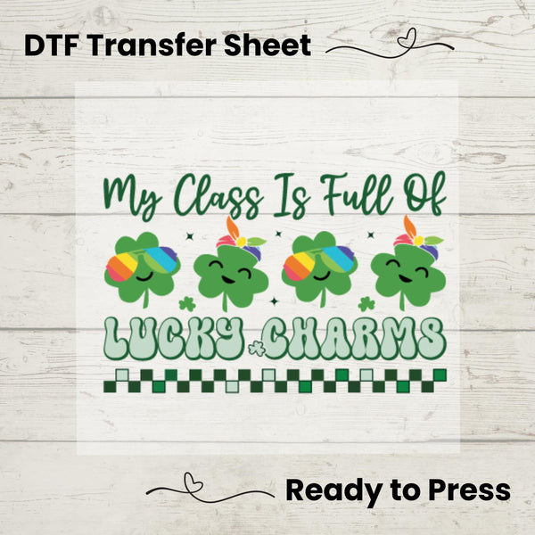 A graphic design on a white background depicting multiple rainbow-colored lucky charms and shamrocks with the text 'My Class Is Full Of Lucky Charms' arranged in a line.