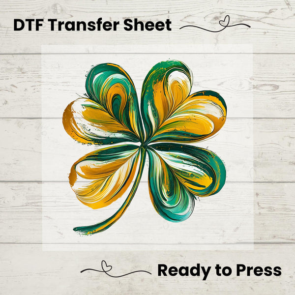 A shamrock-shaped DTF transfer sheet in green and yellow colors, ready for pressing onto fabric.