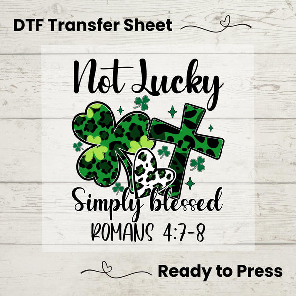 Not Lucky Simply Blessed DTF transfer featuring green leopard shamrocks, hearts, cross, and inspirational Romans 4:7-8 scripture—perfect for DIY faith apparel.