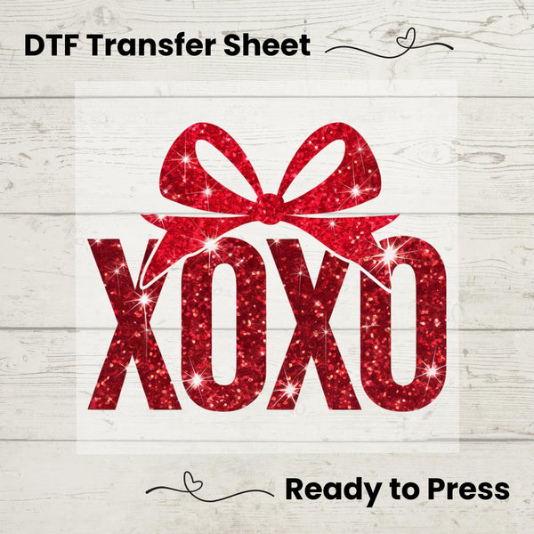 A graphic image of a red sequin 'XOXO' text on a white background, indicating it is a design for a heat transfer vinyl sheet, ready to press onto fabric.